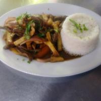 80. Lomo Saltado Carne · Sliced beef stir-fried with red onions, tomatoes, soy sauce, vinegar and cilantro mixed with...