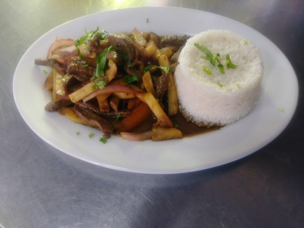 80. Lomo Saltado Carne · Sliced beef stir-fried with red onions, tomatoes, soy sauce, vinegar and cilantro mixed with french fries and served with white rice.
