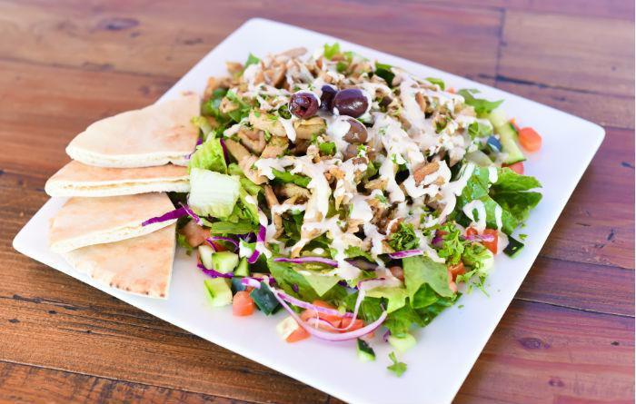 chicken salad  · Romaine lettuce, tomatos, onions, cucumbers, olives and pickles tossed in  our house made dressing and topped with  chicken gyro with tahini sauce 