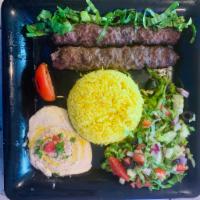Grilled Kafta plate · Two grilled ground Beef & Lamb Kafta Kabab served with hummus, rice, bread and salad.