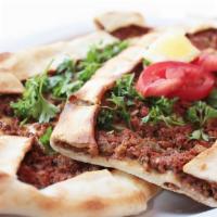 Ground Beef Pizza ·  Oval shape flat-bread with ground beef, onion, tomato,green onion, pepper and parsley. 