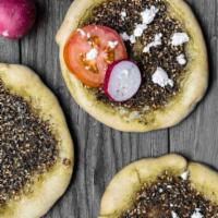 Zaatar Pastry  · Round pide with Zattar topped with feta cheese.  Great for any time of the day with Taziki s...