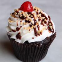 Hot Fudge Sundae Cake · Our chocolate cake filled with fudge and topped with our buttercream and garnished with fudg...
