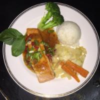 32. Grilled Salmon · Grilled norwegian salmon filet with choices of Thai coconut curry sauce spicy or tamarind sa...