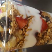 Fresh Fruit yogurt parfait · Low Fat Vanilla Yogurt, Strawberry, Blueberry, Banana, Almonds, raisins, Honey Granola. Serv...