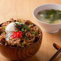 Gyu Don · Thinly sliced beef simmered in sweet sauce and a poached egg on top over rice, served with m...