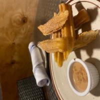 Churros · Churros tossed in cinnamon and sugar served with chocolate sauce