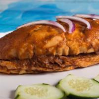 Torta Ahogada · Carnitas sandwich soaked with a delicious but spicy hot red pepper (Arbol) sauce, refried be...