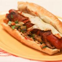 Tejano Hot Dog · Large hot dog wrapped with bacon, grilled onions, and jalapenos topped with chili and melted...