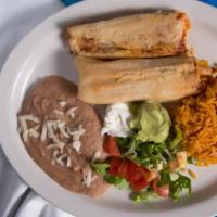 Tamale Plate · 2 hand made pork tamales serviced with refried pinto beans, MX rice, lettuce, and tomatoes.