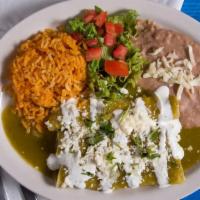 Enchiladas Plate · 3 enchilada in a spicy sauce served with lettuce, tomatoes, MX sour cream, and refried pinto...