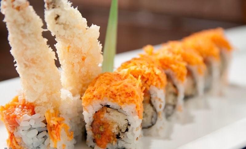 Angry Dragon Roll · Shrimp tempura and spicy tuna inside topped with spicy snow crab, Yuzu miso and eel sauce