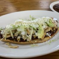 Huaraches · A handmade fried corn tortilla with beans inside and with little green or red sauce, with yo...