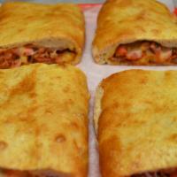 Meat lover's Stromboli · Contains bacon, chicken, ham, pepperoni and sausage,mozzarella cheese & marinara sauce