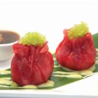 Tuna Wasabi Dumpling · Tuna wrapped with avocado tobiko and crunch drizzled in wasabi sauce. 