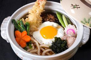 Nebeyaki Udon · Chicken and egg udon soup with two tempura shrimp on the side. (for delivery orders, it's re...