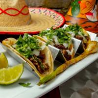 American Taco · Served with your choice of meat. Tacos Americanos servidos con cebolla, cilantro, tomate, le...