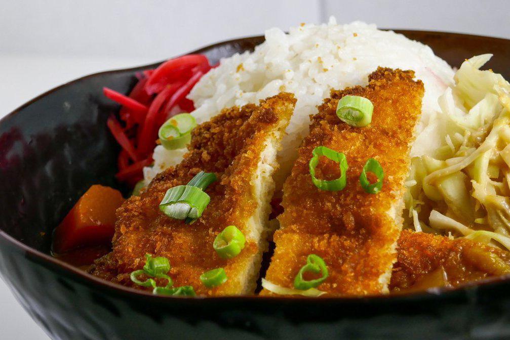 Japanese Curry  w/ Panko Chicken · House-made curry. Pleasantly sweet and savory with potatoes and carrots, topped with white meat panko-breaded chicken on steamed white rice.