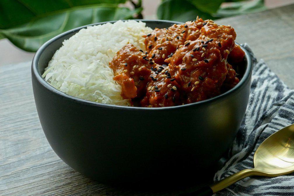 Red Dragon Rice Bowl · Tender crispy chicken tossed in a spicy thai chili sauce, on a bed of steamed white rice topped with sesame - this will have you breathing fire! Spice level: 3