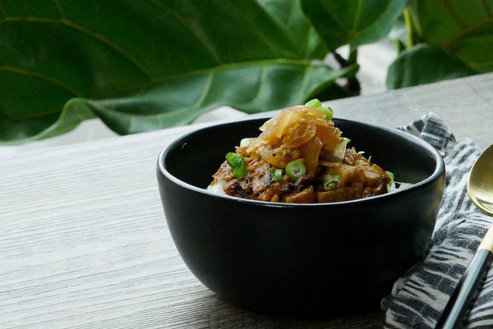 Pork Belly Rice · Chopped seared pork belly on steamed white rice, topped with a sweet onion drizzle and spring onion.