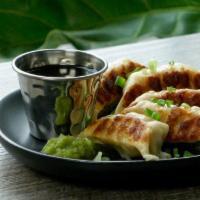 Chicken Gyoza (5) · Pan-fried chicken and vegetable dumplings with yuzu kosho, served with a soy dipping sauce.