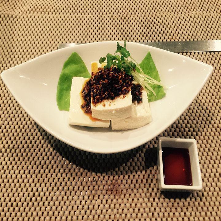 Spicy Hiyayakko · Chilled tofu with radish, sprouts, and homemade chili sauce.