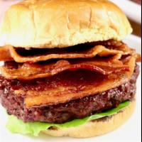 Burger Boss Ultimate · A char broiled beef burger with a bacon and ham on top with melted Swiss cheese and American...