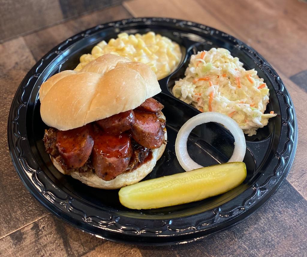 Chopped Brisket and Sausage Sandwich · Pitmaster Aaron’s favorite. It comes with chopped beef brisket, BBQ sauce, plus your choice either jalapeno and cheddar or cracker pepper sliced sausage, then more BBQ sauce. It's truly a real BBQ sandwich! - Sandwich Only