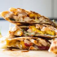 Q1. Chicken Quesadilla · Grilled chicken, grilled onions, peppers, melted cheddar cheese, mozzarella cheese, and sour...