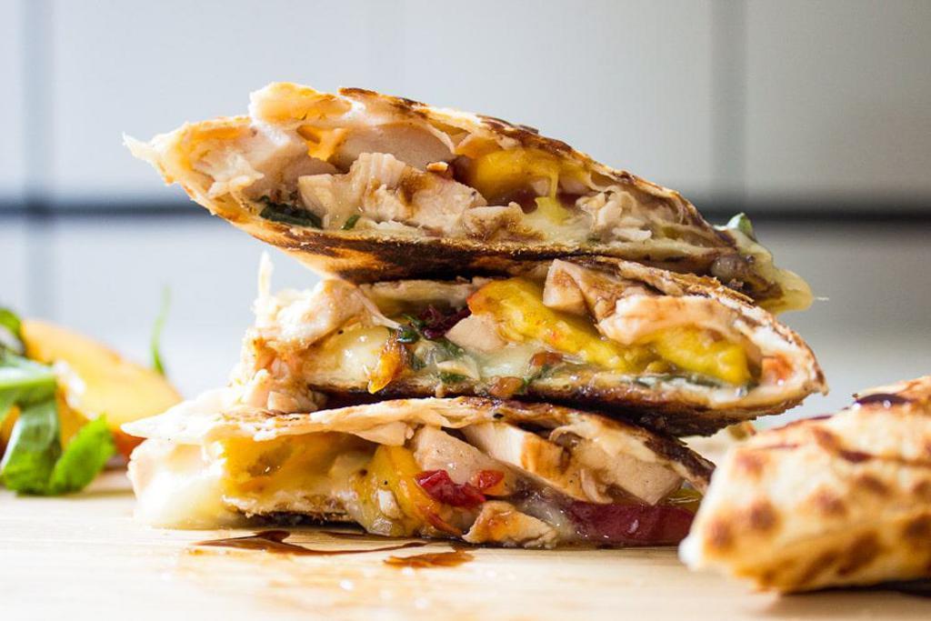 Q1. Chicken Quesadilla · Grilled chicken, grilled onions, peppers, melted cheddar cheese, mozzarella cheese, and sour cream.
