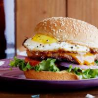B2. Texas Burger · Beef patty, fried egg, Swiss cheese, lettuce, pickles & 1000 Island dressing.