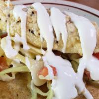 Baja Style Fish Taco · Beer battered fish, cabbage, pico, lime crema