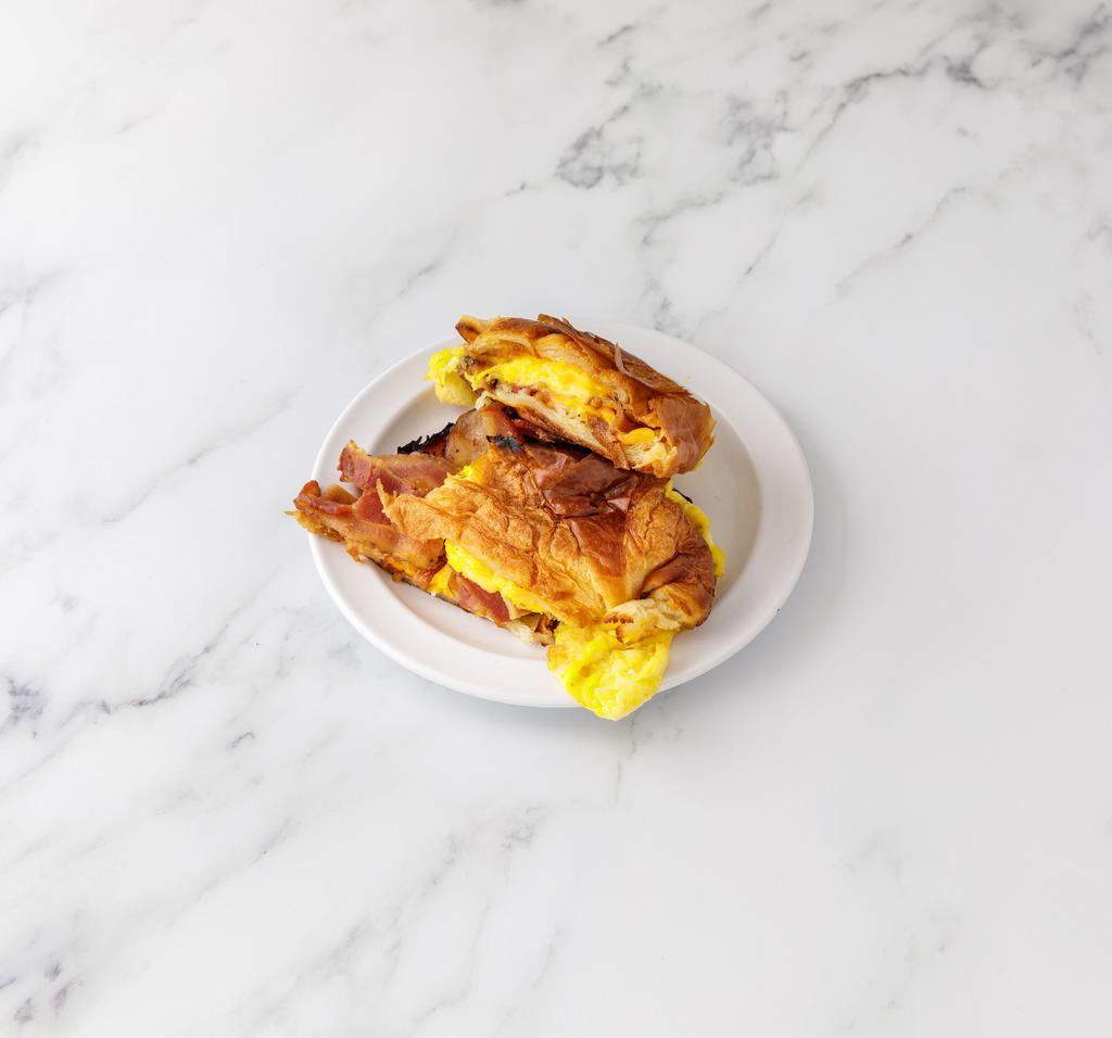Breakfast on a Croissant · two eggs freshly cooked,  your favorite meat added on it  with a delicious melted cheese on a just baked Croissant.