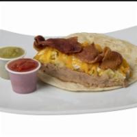 Cowboy Signature Breakfast Taco · Contains Scrambled eggs, potatoes, bacon, beans, and cheddar cheese 
