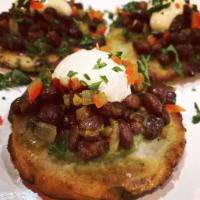 Seedy Arepas · Pumpkin and sunflower seed corn patties topped with black bean and cabbage slaw with avocado...