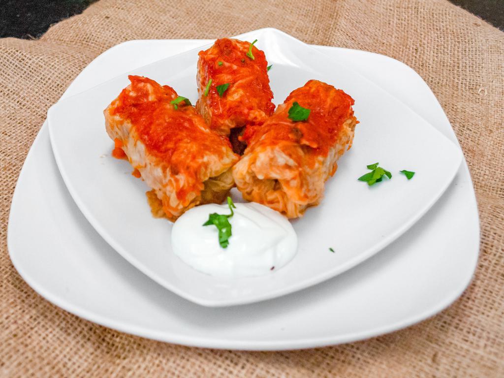 Cabbage Rolls 3pc · Seasoned Beef, Chicken and Rice filling rolled in a cabbage leaf toped with homemade tomato sauce. 