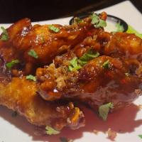 Bacon Wings · 6 wings on our homemade bacon wing sauce, topped with chopped bacon