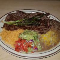 Carne Asada · Seasoned fillets of steak char-broiled and garnished with grilled onions and a jalapeno pepp...