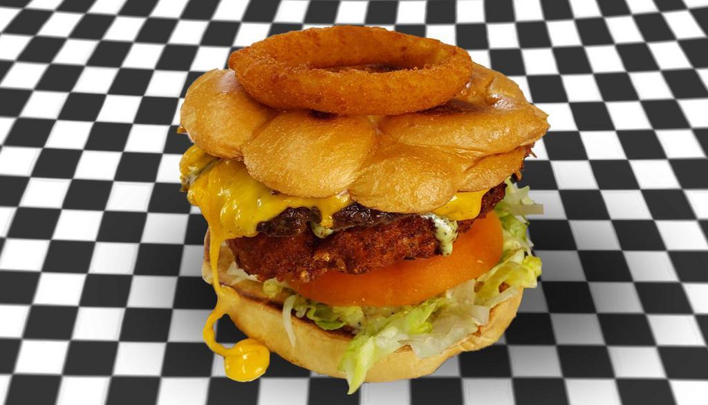 Special Aleida's Burger · 1 beef meat, 1 fried chicken, double yellow cheese, pickles, bacon, lettuce, tomato, 1 onion ring, with french fries, and Aleida's sauce.