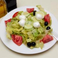 House Salad · Romaine lettuce, tomato, cucumbers, black olives and fresh mozzarella. Served with bread.