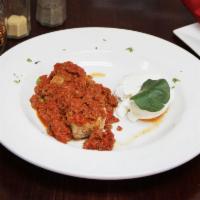Meatballs Bolognese · Homemade meatballs served in a meat sauce with peas, topped with ricotta cheese. 