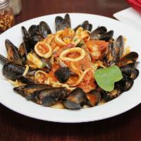 Seafood Pescatore Dinner · Jumbo shrimp, calamari, mussels and clams in a marinara sauce over linguini. Served with sou...