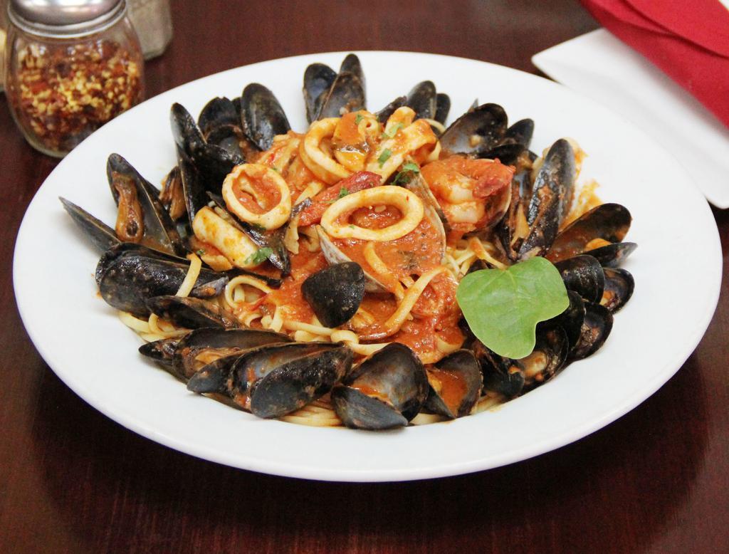 Seafood Pescatore Dinner · Jumbo shrimp, calamari, mussels and clams in a marinara sauce over linguini. Served with soup or salad, pasta or potatoes and vegetable of the day. 