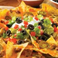 Nachos Grande · Tortilla chips, chili, Jack cheese, lettuce, salsa, sour cream and jalapenos.