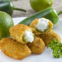 Jalapeno Poppers · 6 pieces. Stuffed with cheddar cheese, lightly breaded and deep fried. Served with sour cream.