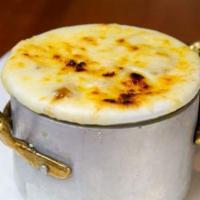 French Onion Soup · Topped with melted mozzarella, and served in a crock.