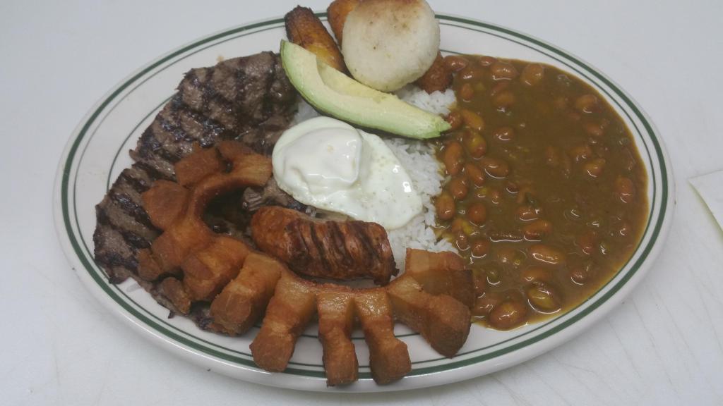 34. Typical Platter · Grilled beef, pork skin, sausage, egg, corn cake, sweet plantain, rice, beans and avocado.