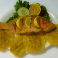48. Fried Red Snapper · Served with rice, fried green plantain and salad.