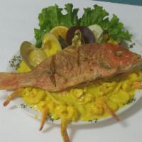 55. Red Snapper Topped with Seafood · Served with rice, french fries and salad.