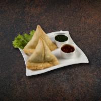 Samosa Royale · Cumin-flavored potatoes and peas filled in pastry dumpling and golden fried served with mint...
